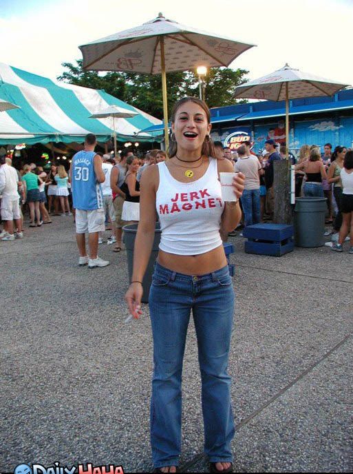 A woman in a white tank top and jeans standing in front of a tent.