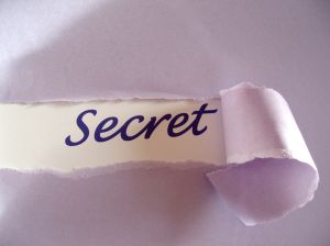A piece of paper with the word secret written on it.