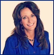 A woman with long hair wearing blue shirt.